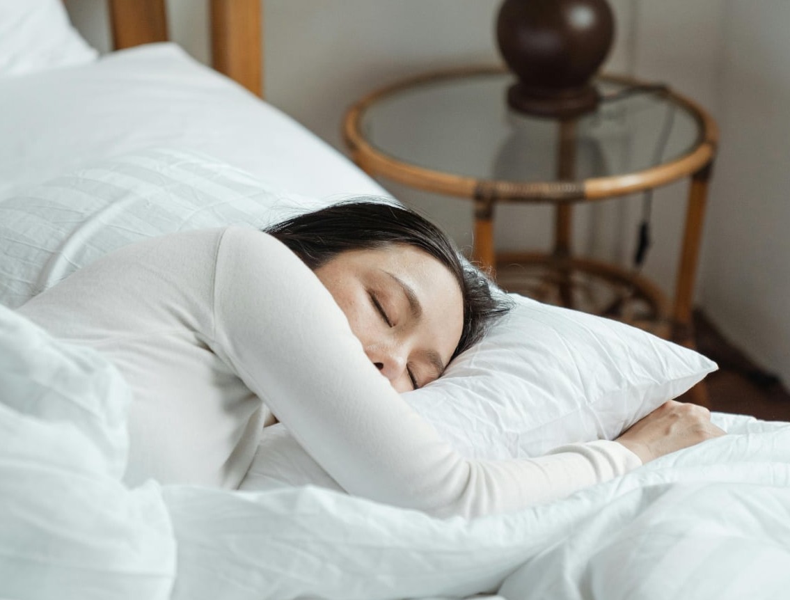 Young woman sleeping in a bed