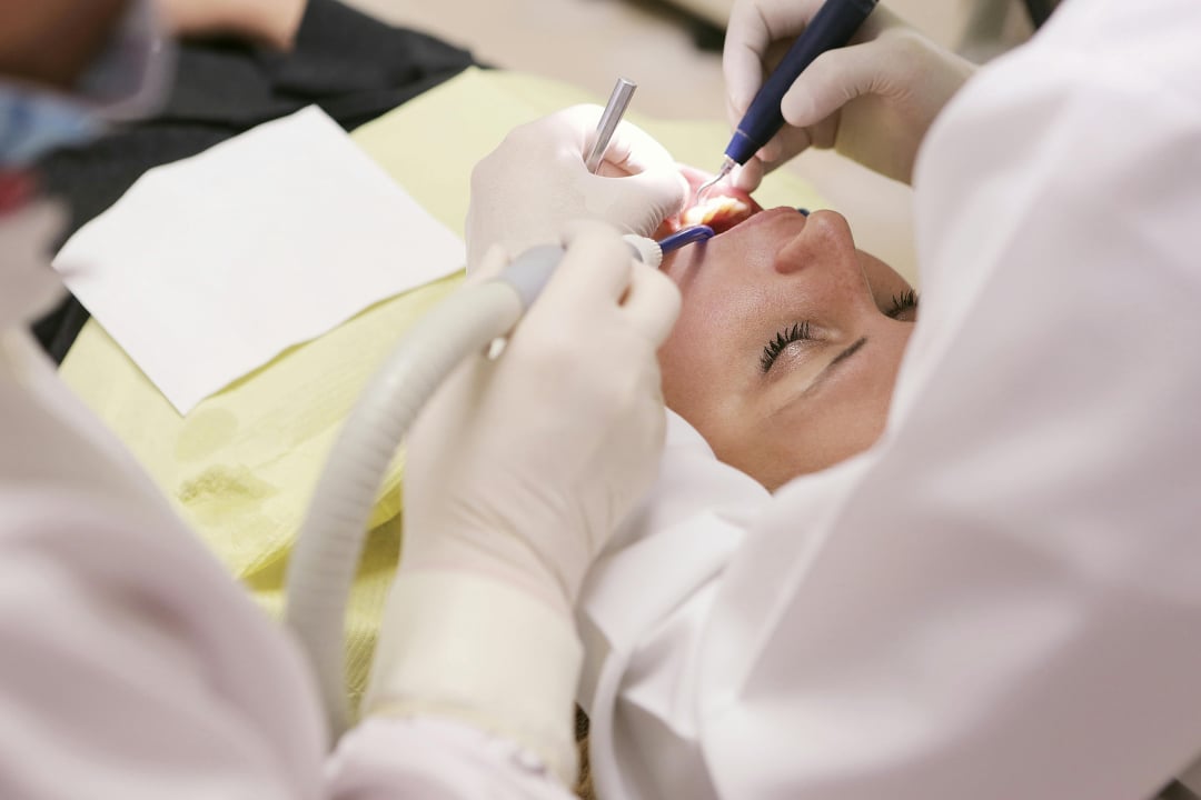 Dentist treating a smiling patient