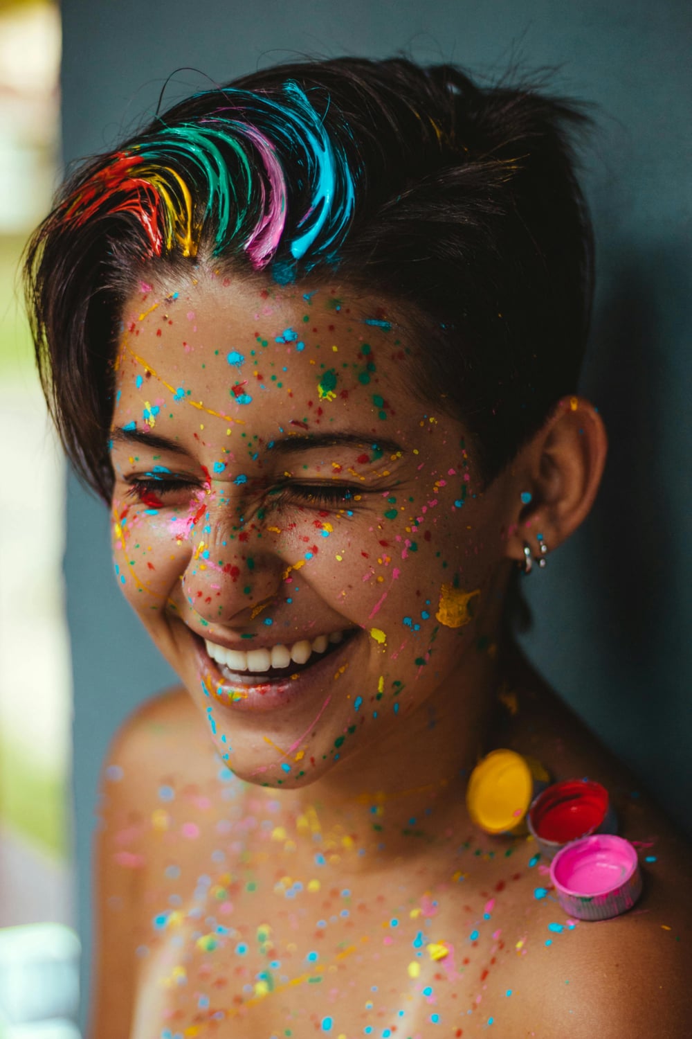 Woman smiling with colors paint on her face